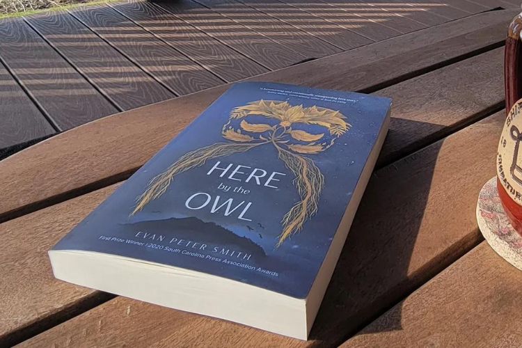 Here by the Owl print book by Evan Peter Smith displayed on a wooden table