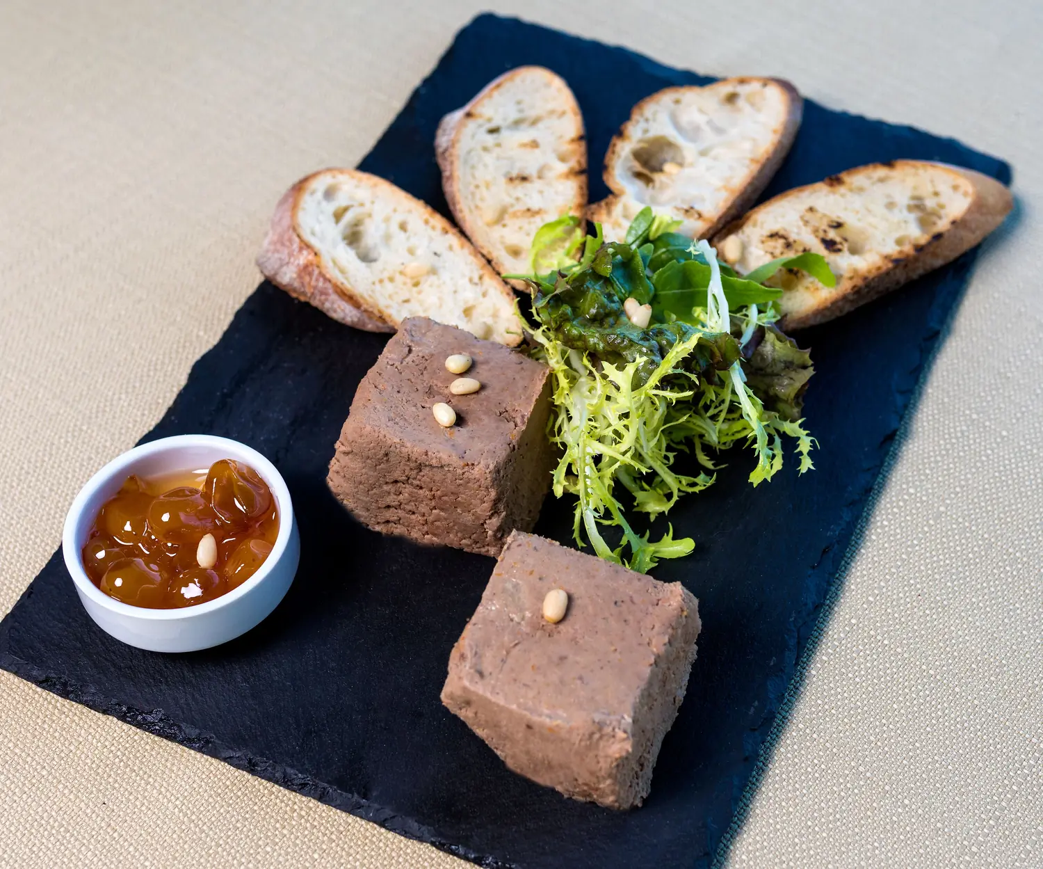 Liver pate terrine served with grilled crostini and onion jam